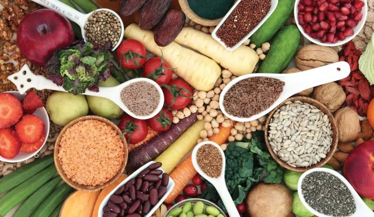 The image is a colorful array of various healthy foods and seeds, depicting a diverse and nutritious selection from Medical Medium recipe book