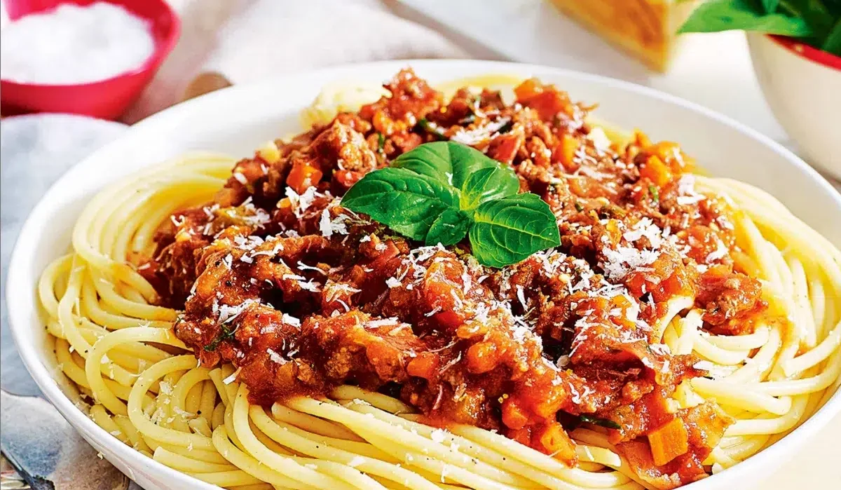 The image features a generous serving of TikTok Spaghetti Recipe pasta topped with a rich and hearty meat sauce.