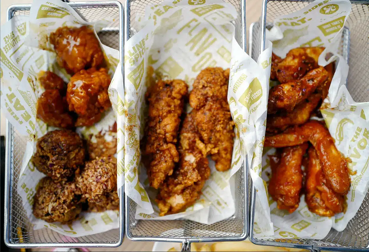 The image shows three varieties of fried chicken presented in baskets lined with branded paper from Wingstop Ranch Recipe