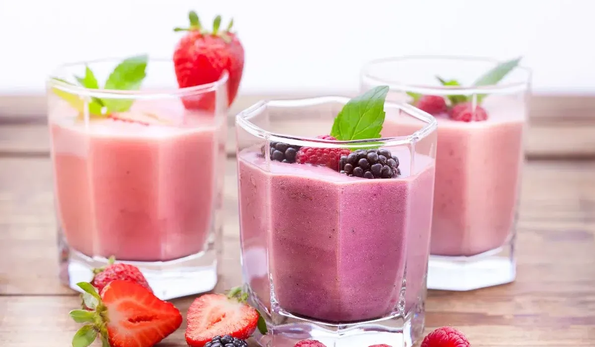 The image shows three glasses of Grimace Shake Recipe with two distinct layers of colors, indicating a mix of different fruits.