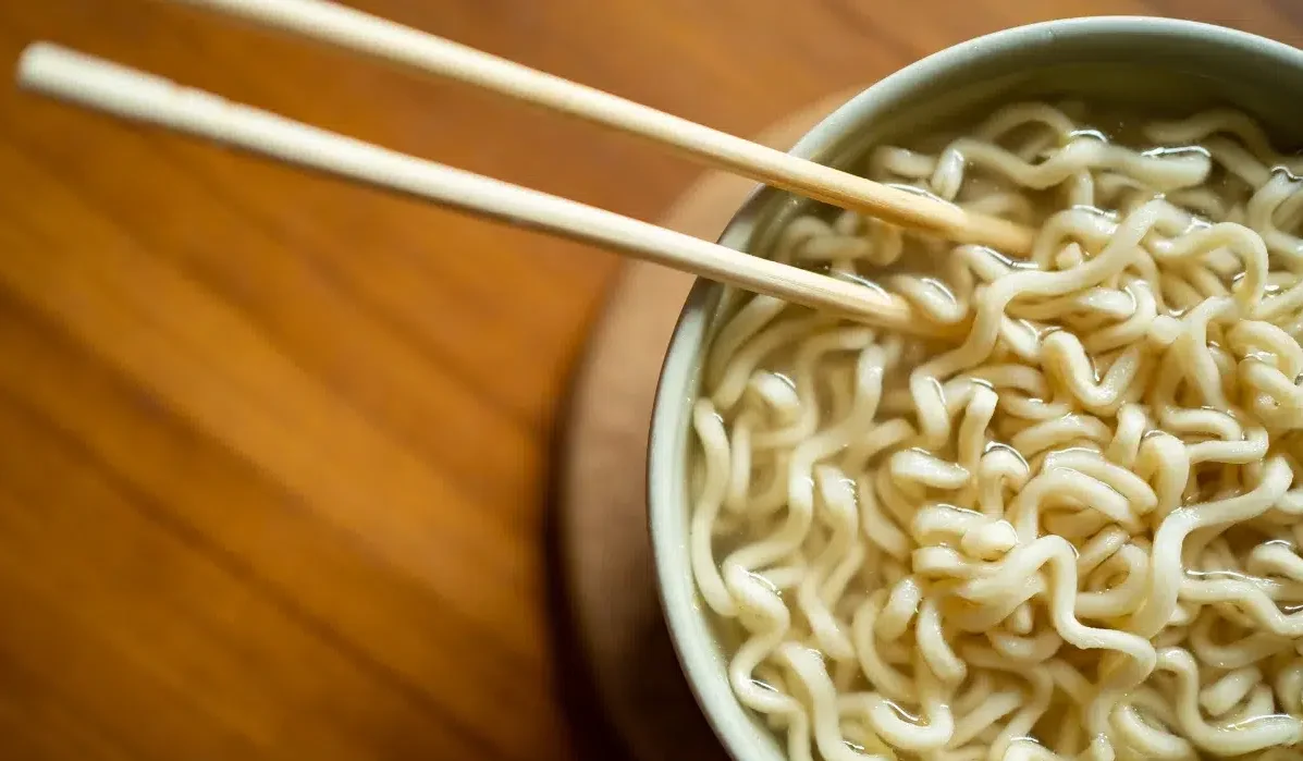 The image shows a close-up view of a bowl of instant packaged ramen.