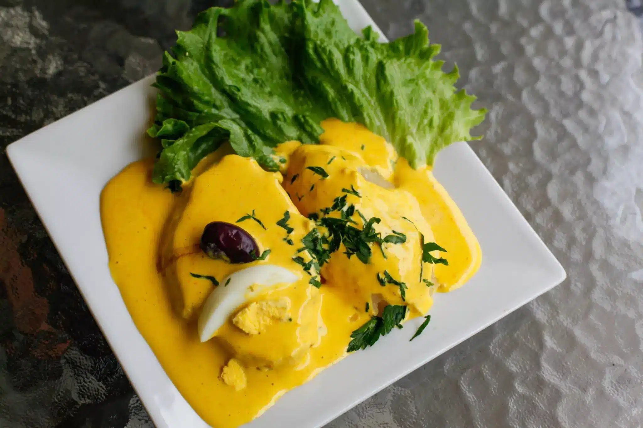 image of yellow sauce and green lettuce on white plate