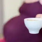 The image features a pregnant woman sitting in a chair, holding whats is called 'midwives brew recipe'