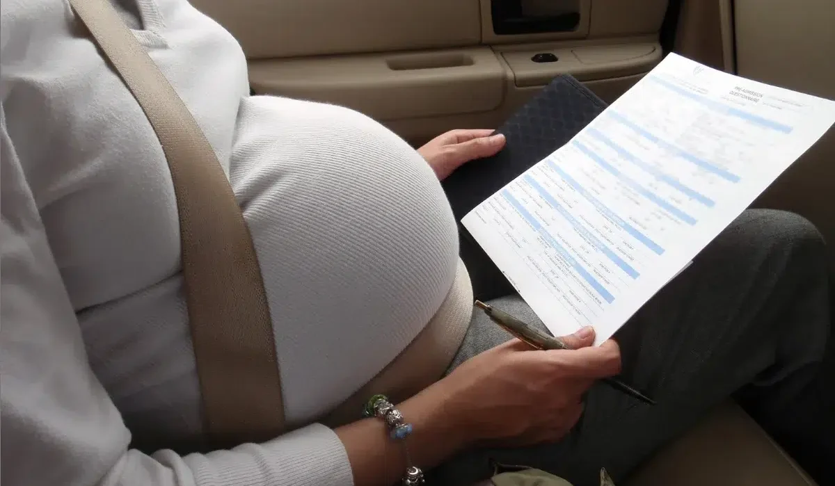 image of a pregnant woman looking at a recipe for a drink to induce labor at home