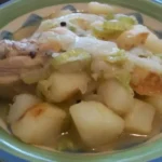 a green plate of likely a chicken souse