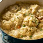 Creamy chicken and dumplings recipe served in a rustic kitchen