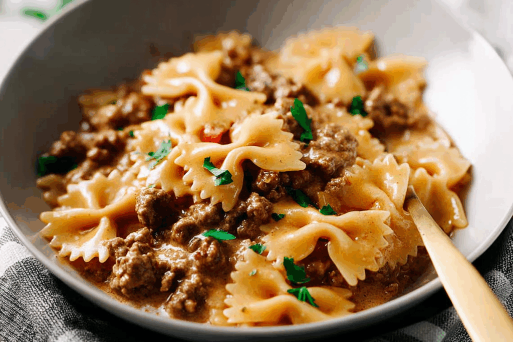 Creamy Ground Beef and Bowtie Pasta served hot with melted cheese