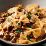 Creamy Ground Beef and Bowtie Pasta served hot with melted cheese