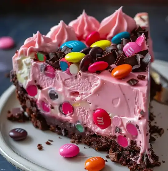 Mixing pink cheesecake filling for Snickers M&M cheesecake