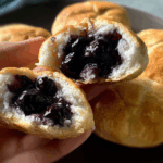 Freshly baked blueberry pie bombs on baking tray