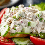 Creamy chicken salad recipe served in a rustic bowl with croissants