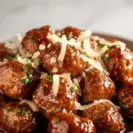Crock Pot French Onion Meatballs with melted Gruyère cheese
