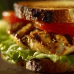 garlic butter lettuce tomato & grilled chicken sandwich close-up