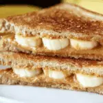 Grilled peanut butter banana sandwich with golden toasted bread
