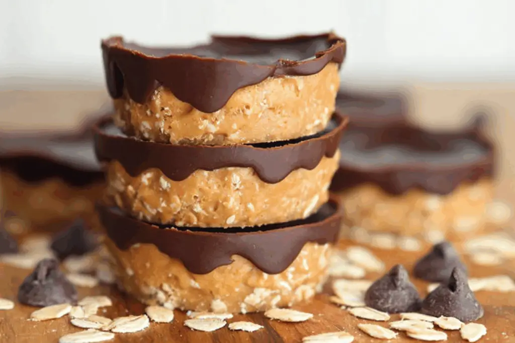 No-bake peanut butter oat cups stacked on parchment
