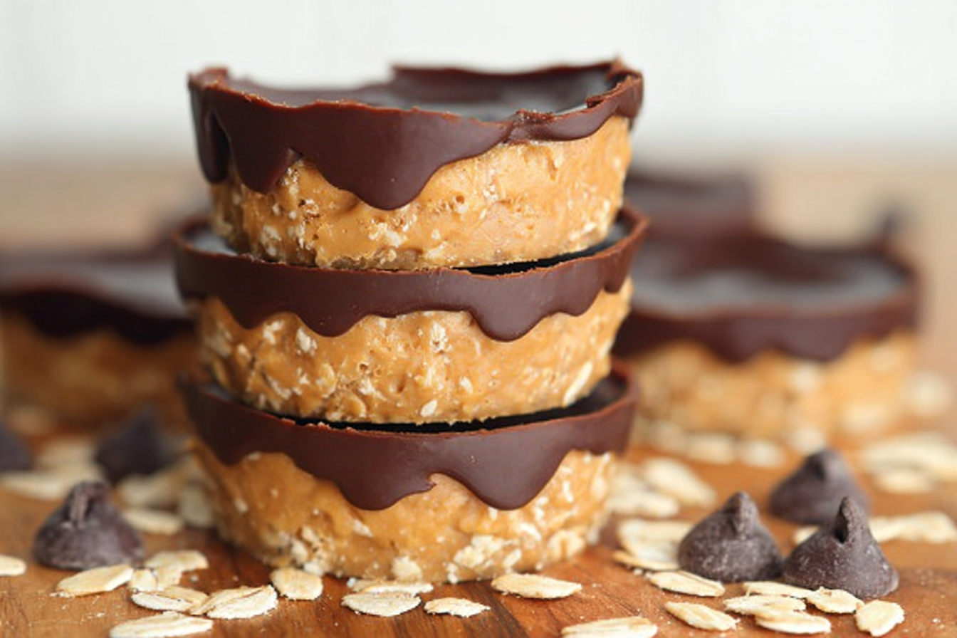No-bake peanut butter oat cups stacked on parchment