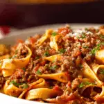 Spaghetti Bolognese recipe served hot with parmesan and basil